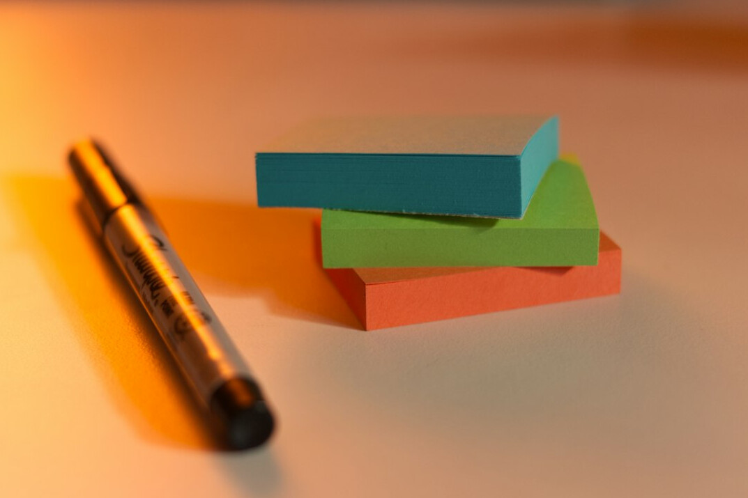 Team brainstorming with sticky notes on a glass wall